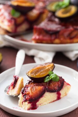 Slice of caramelised plum upside-down cakeの写真素材