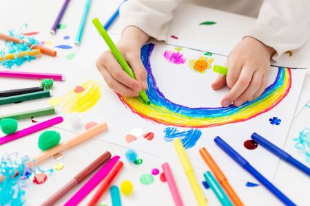 Child draws a rainbow with markers.の写真素材