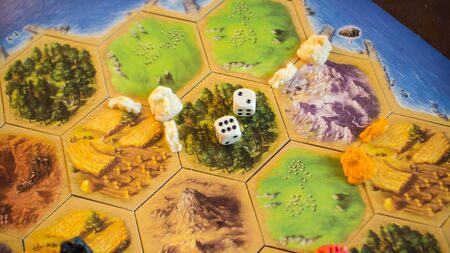 Russia / Saint-Petersburg -30.10.2019: Board game party with my friends. Playing cards. Settlers of Catan popular board game for everybody. Close up shooting in my game with friends.のeditorial素材