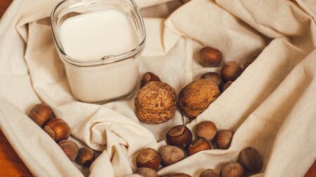 homemade greek yoghurt with walnut and hazelnut nuts and peachの写真素材
