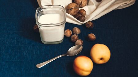 homemade greek yoghurt with walnut and hazelnut nuts and peachの写真素材