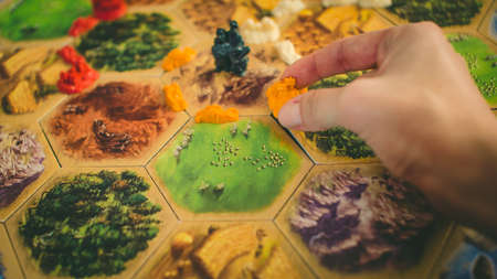 The robber in the Settlers of Catan board game. Katana board game. Game for family. Russia / Saint-Petersburg -30.10.2019のeditorial素材
