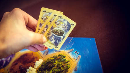 Russia / Saint-Petersburg -30.10.2019: Board game party with my friends. Playing cards. Settlers of...