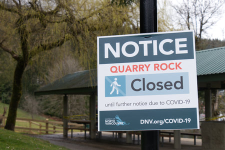 Deep Cove, North Vancouver, Canada - April 1,2020: View of warning sign Quarry Rock Closed until...