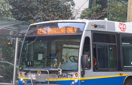 Vancouver, Canada - April 2,2020: Translink bus with sign Rear Boarding Only due to COVID-19