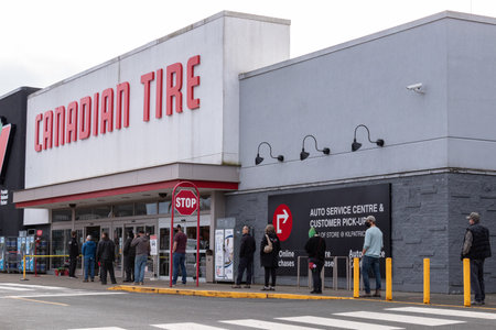 Courtenay, Canada - Nov 21,2020: People are lining up to enter Canadian Tire Store practicing social...