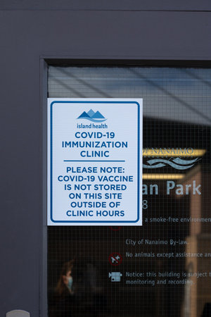 Nanaimo, Canada - March 7,2021: View of entrance building with sign Covid-19  Immunization Clinic. Covid-19 Vaccine is not stored on this site outside of clinic hoursのeditorial素材