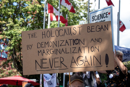 Vancouver, Canada - September 8,2021: View of sign The Holocaust Began by Demonization and Marginalization during the rally against the BC Vaccine Card in front of Vancouver City Hallのeditorial素材