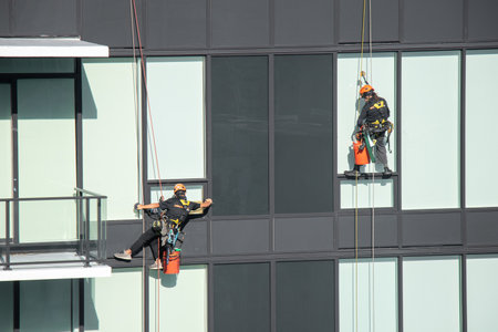 Vancouver, Canada - September 18,2021: Construction worker washes windows one of the residential buildings in Downtown Vancouverのeditorial素材
