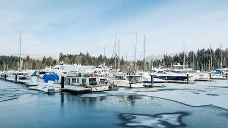 Vancouver, Canada - December 28, 2021: A View of frozen dock with boats in Coal Harbour. Snow storm...