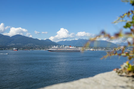 Vancouver, Canada - July 1,2022: Cruise ship is leaving Canada Place pier and heading towards the Lions Gate Bridge. North Vancouver in the background.のeditorial素材