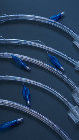 endotracheal tubes of different diameters lie on a dark background. close up