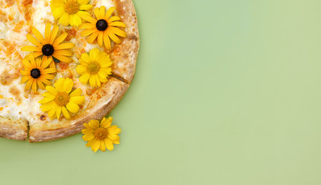 pizza with flowers in green background close-upの写真素材
