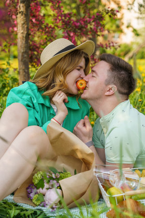 close-up portrait young couple, enjoying picnic in parkの写真素材
