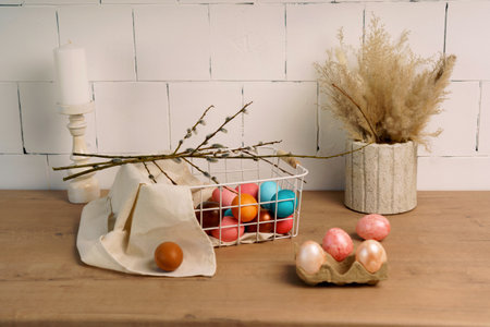 preparation for Easter. painted Easter eggs in kitchen on wooden countertop surrounded by home...