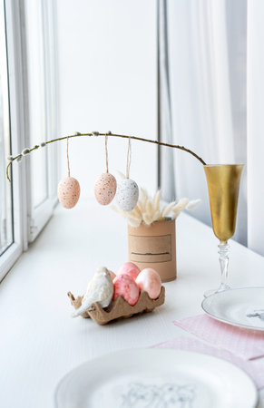 Table set with dishware, stemware, and Easter decorations