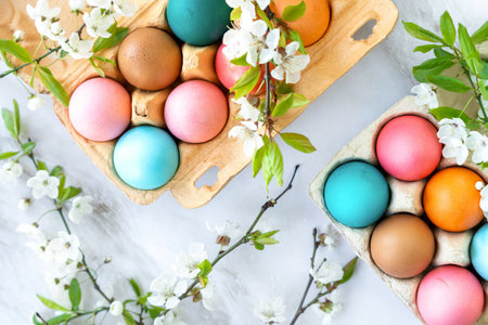 colorful Easter eggs in a package decorated with flowering tree branches. spring holidays,...