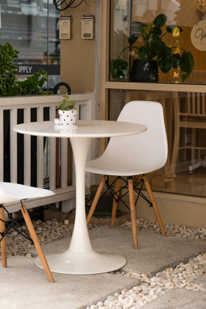 Table and chair set made of wood, placed outdoor next to a buildingのeditorial素材