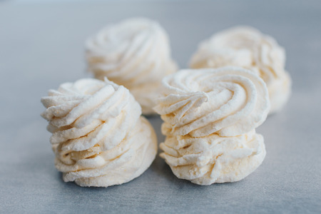 White mango marshmallows or zephyr with sugar powder on a table. Homemade sweet.の写真素材
