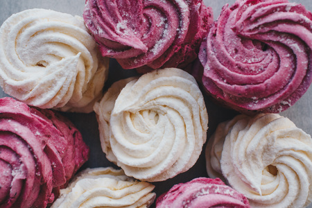 White mango and pink blueberry marshmallows or zephyr with sugar powder on a table. Homemade sweet.の写真素材