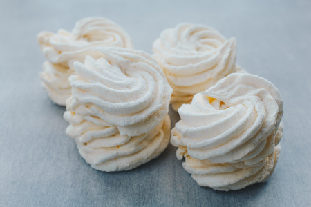 White mango marshmallows or zephyr with sugar powder on a table. Homemade sweet.の写真素材