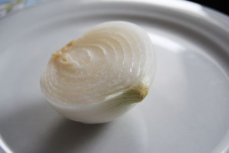 white onion cut in half on a serving plateの写真素材