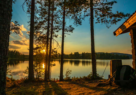 breathtaking sunset on a summer evening on a Swedish lakeの写真素材