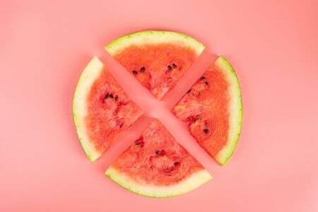 Watermelon slices on a pink background. Healthy food concept. Ripe juicy watermelon.