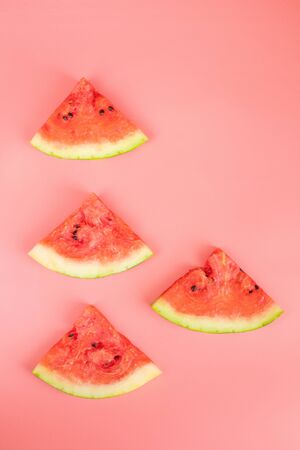 Watermelon slices on a pink background. Healthy food concept. Ripe juicy watermelon.の写真素材