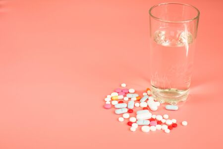 Minimalism. Medicine concept many different pills on pink background. Copy space text.の写真素材