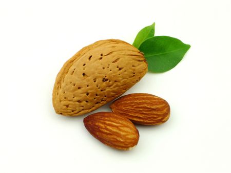 Almonds with leaves on a white backgroundの写真素材