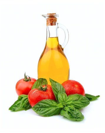 Bottle of oil and tomatoes with basilの写真素材