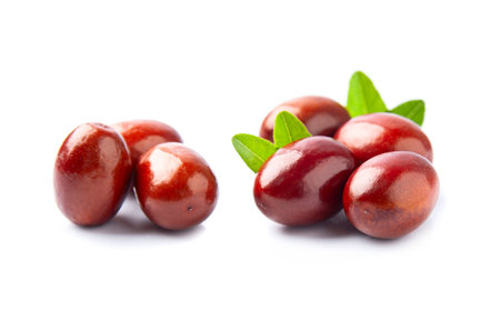 Dates fruits with leaves on white backgrounds.