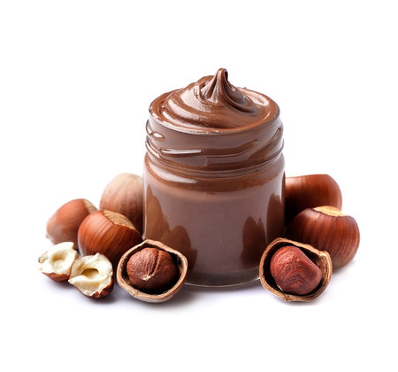 Chocolate butter on glass bottle with hazelnuts on white backgrounds.の写真素材