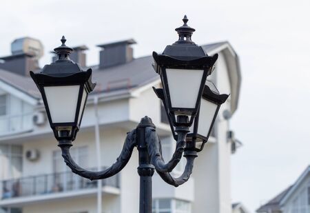 Black street lamp on a background of the house.の写真素材