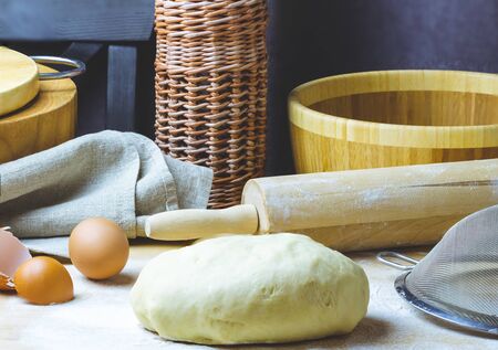 Kitchen utensils for making dough. Sieve, rolling pin, wooden dishes.の写真素材