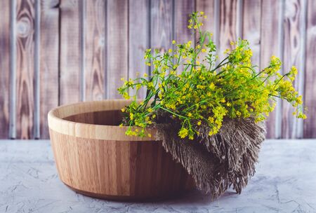 A bouquet of wild yellow St. Johns wort flowers collected in the summer on a meadow for the...