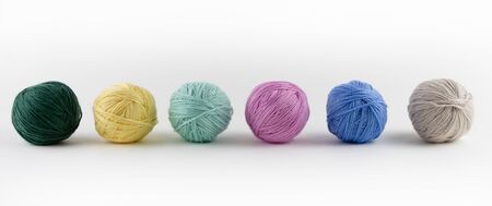 Multi-colored balls of yarn for knitting. Place for text.