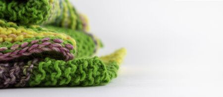 A stack of handmade knitwear. The texture of the knitted fabric. Knitting. Bright multi-colored paints.の写真素材