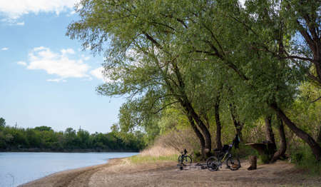 Russia. Krasnodar on April 30, 2020. Cyclists relax in the parking lot. The bank of the Kuban River.のeditorial素材