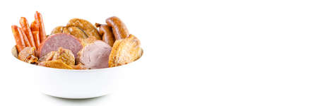 Assortment of sausages on a wooden plate on a white background. Smoked meat products.の写真素材