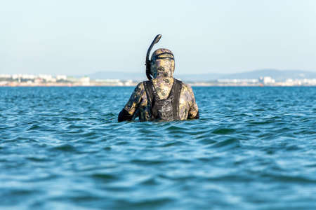 Diver with diving equipment at sea. The man is fishing in the sea. Spearfishing.の写真素材