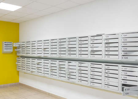 Walls with mailboxes in a new modern high-rise building.