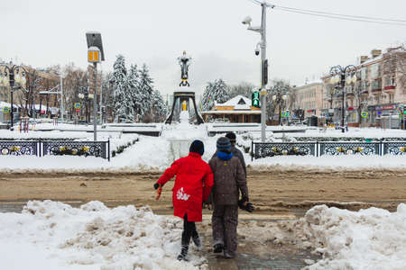 Russia. Krasnodar, February 7, 2021. Children cross the road at the green light. The central street...