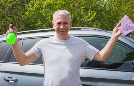 Young man washing the car with a sponge High quality photo