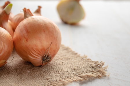 Yellow onions on burlap. Autumn harvest, vegetarianism, food, vegetables Vegan foodの写真素材