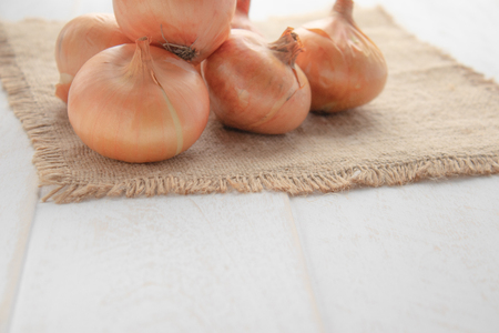 Yellow onions on burlap. Autumn harvest, vegetarianism, food, vegetables Vegan foodの写真素材