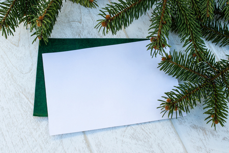 Green branches of a Christmas tree and cones on the background of white boards. Place for text. View from above.の写真素材