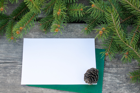 Green branches of a Christmas tree and cones on the background of old, wooden boards. Top view with copy space for your text.の写真素材