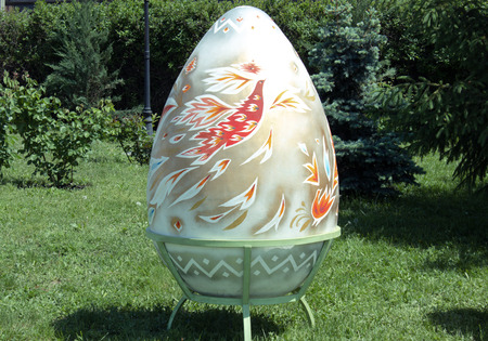 Decorative large eggs are on the street on the grass. Painting decorative eggs.の写真素材